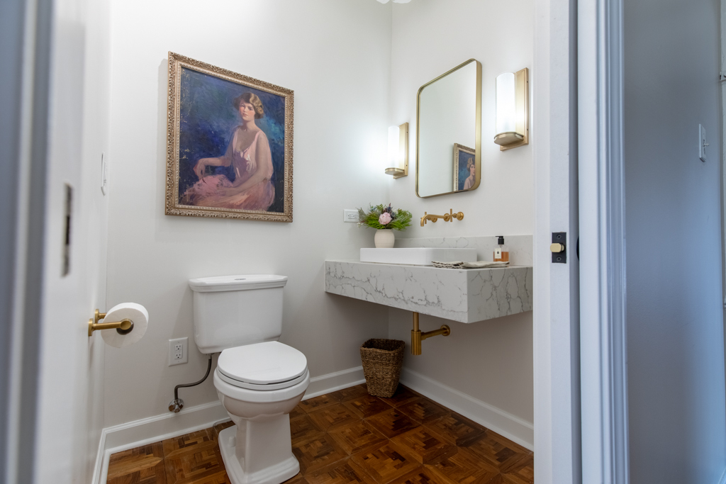 727 South Dearborn Street, Unit 910 Chicago, IL 60605 - Photo 8 of 37 a bathroom with a toilet sink and mirror