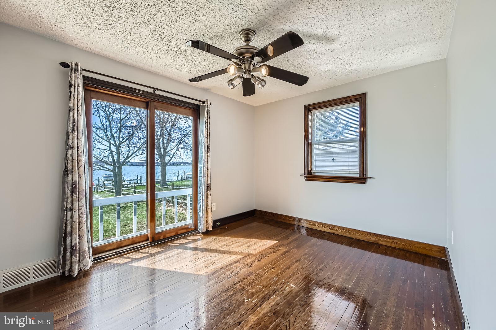 1004 Thompson Boulevard Baltimore, MD 21221 - Photo 18 of 48 a view of an empty room with wooden floor and a window