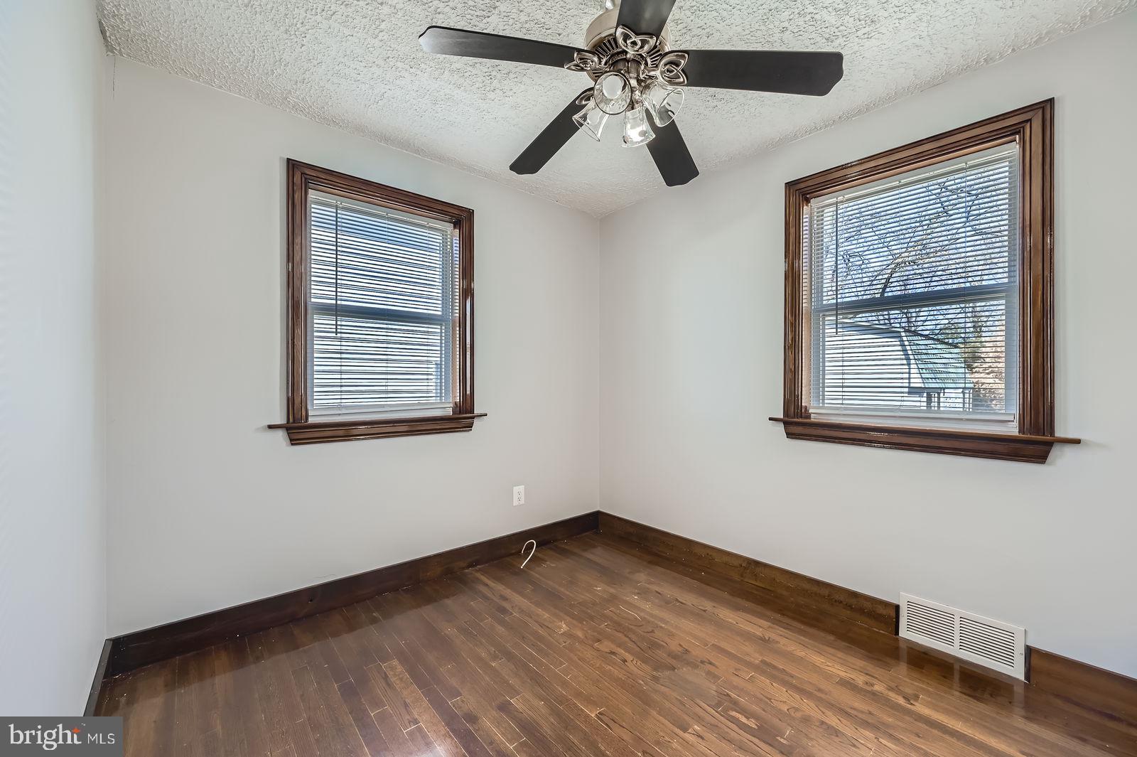 1004 Thompson Boulevard Baltimore, MD 21221 - Photo 20 of 48 a view of an empty room with wooden floor and a window