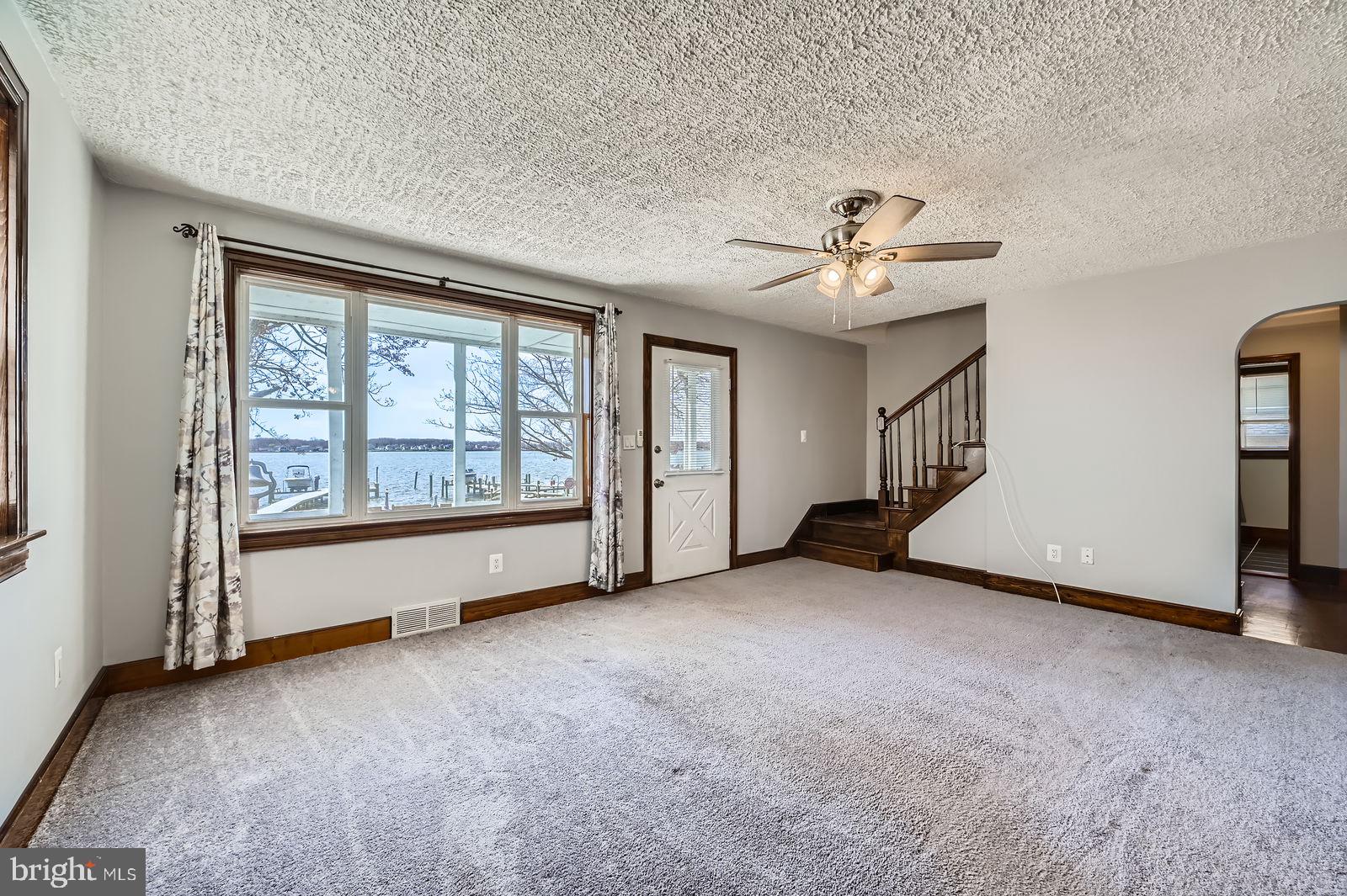 1004 Thompson Boulevard Baltimore, MD 21221 - Photo 21 of 48 an empty room with chandelier fan and windows