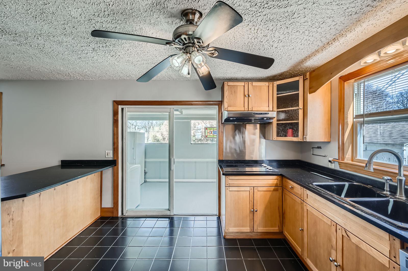 1004 Thompson Boulevard Baltimore, MD 21221 - Photo 29 of 48 a kitchen with stainless steel appliances granite countertop a sink a counter space cabinets and stainless steel appliances