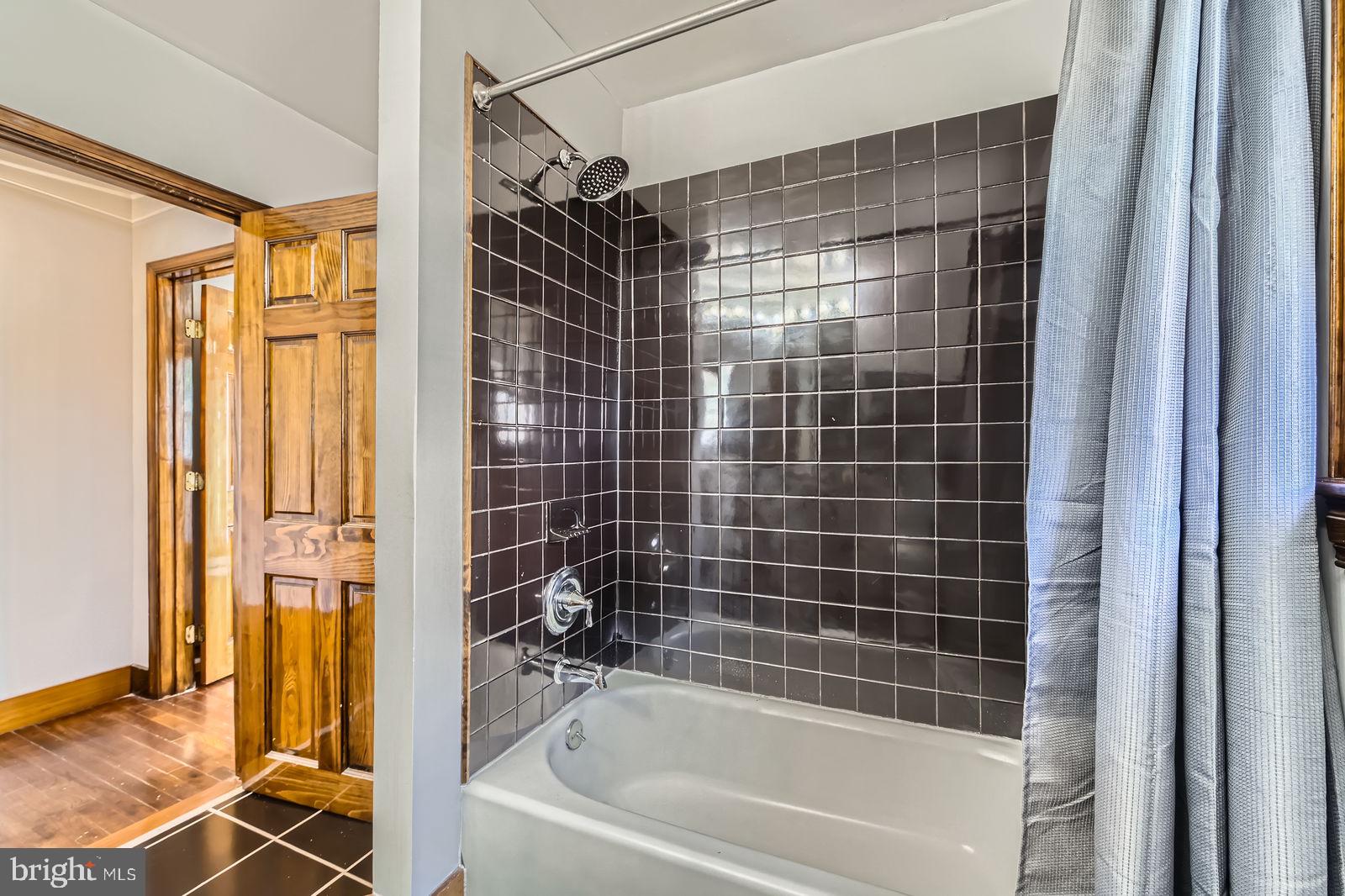 1004 Thompson Boulevard Baltimore, MD 21221 - Photo 32 of 48 a bathroom with a shower and a bathtub