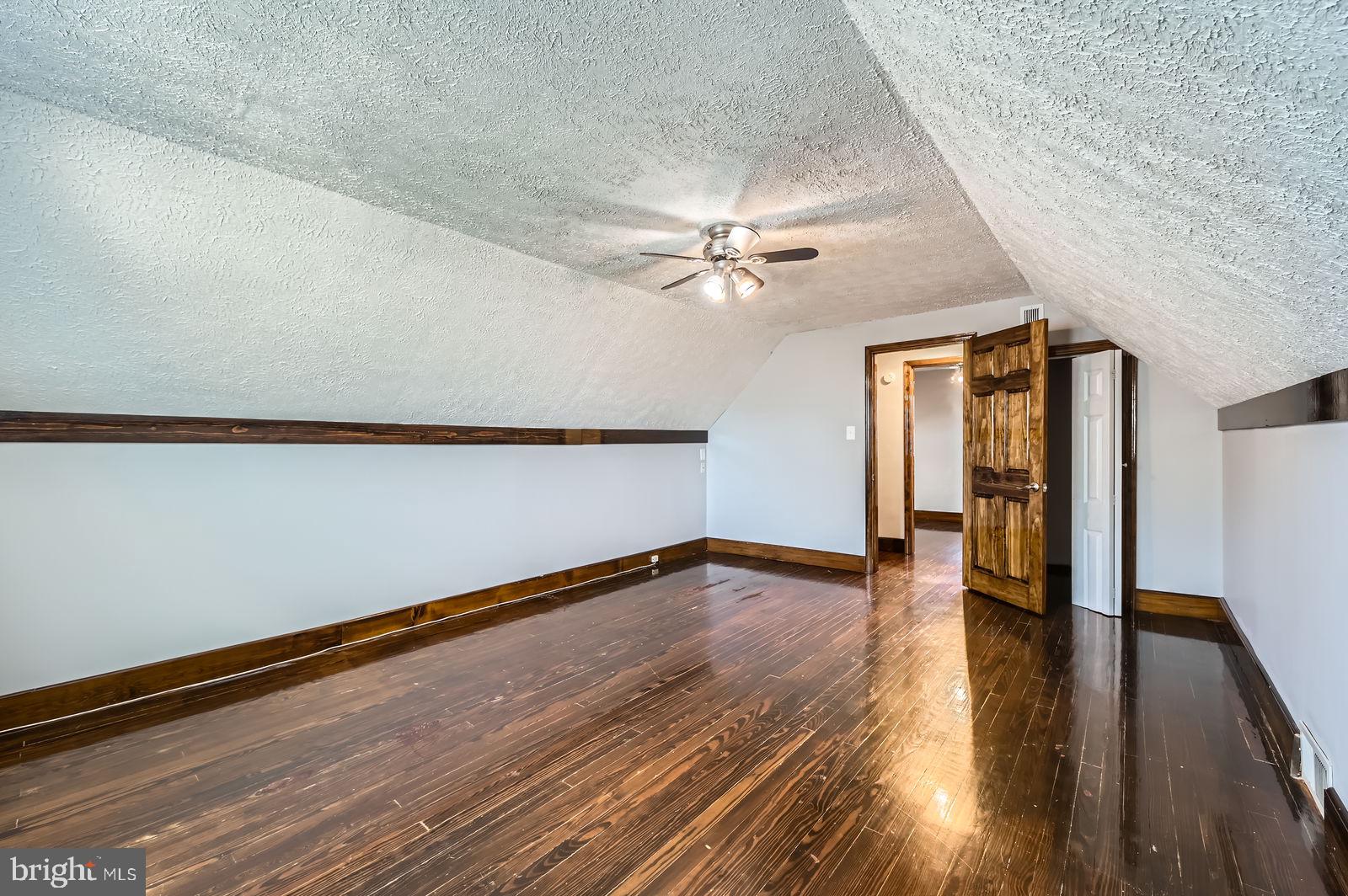 1004 Thompson Boulevard Baltimore, MD 21221 - Photo 33 of 48 a view of an empty room with wooden floor and a window