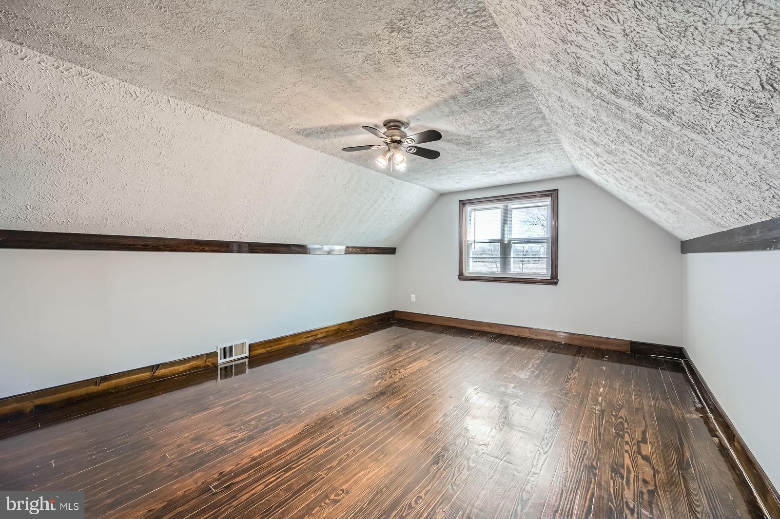 1004 Thompson Boulevard Baltimore, MD 21221 - Photo 34 of 48 wooden floor in an empty room with a window