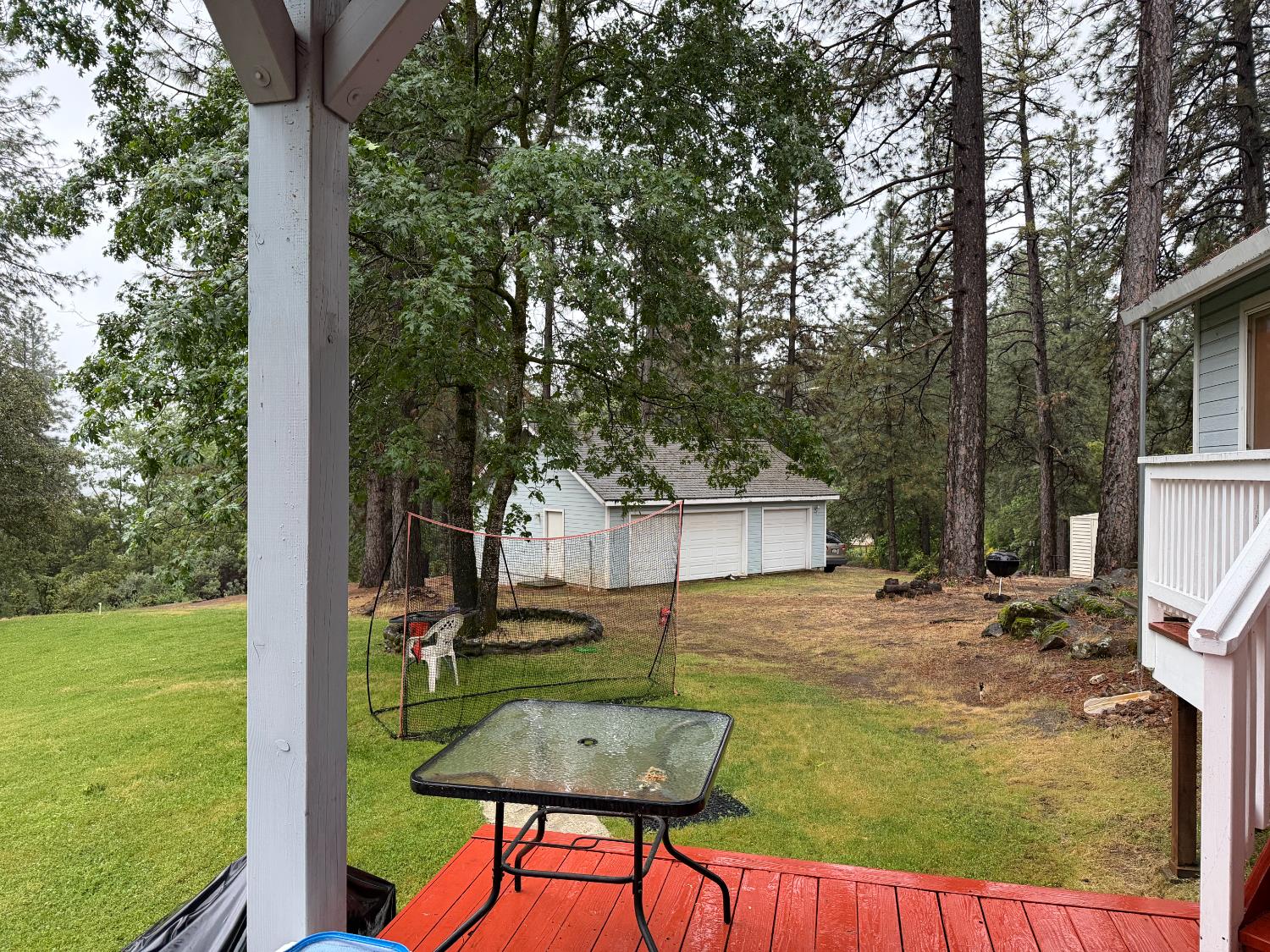645 Rigby Lane Applegate, CA 95703 - Photo 16 of 52 a view of a backyard with table and chairs potted plants and large tree