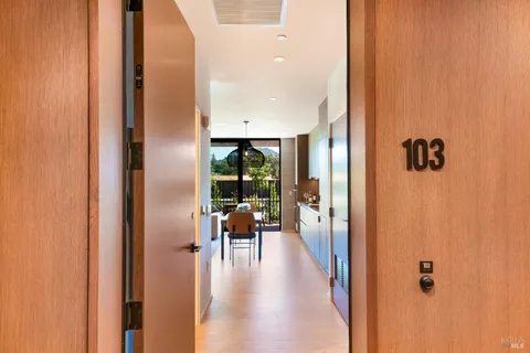 a view of a hallway with living room and dining room view