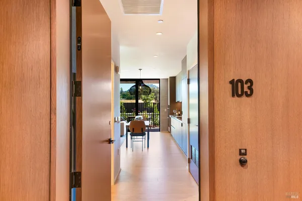 a view of a hallway with living room and dining room view
