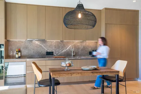 a kitchen with a table and chairs
