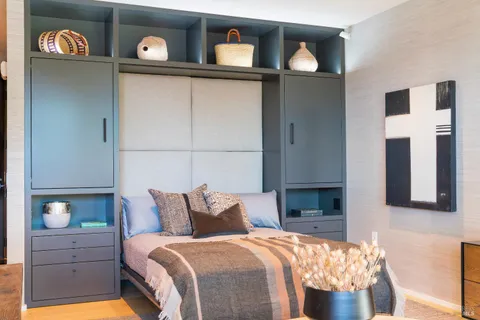 a bedroom with a bed and a lamp on table