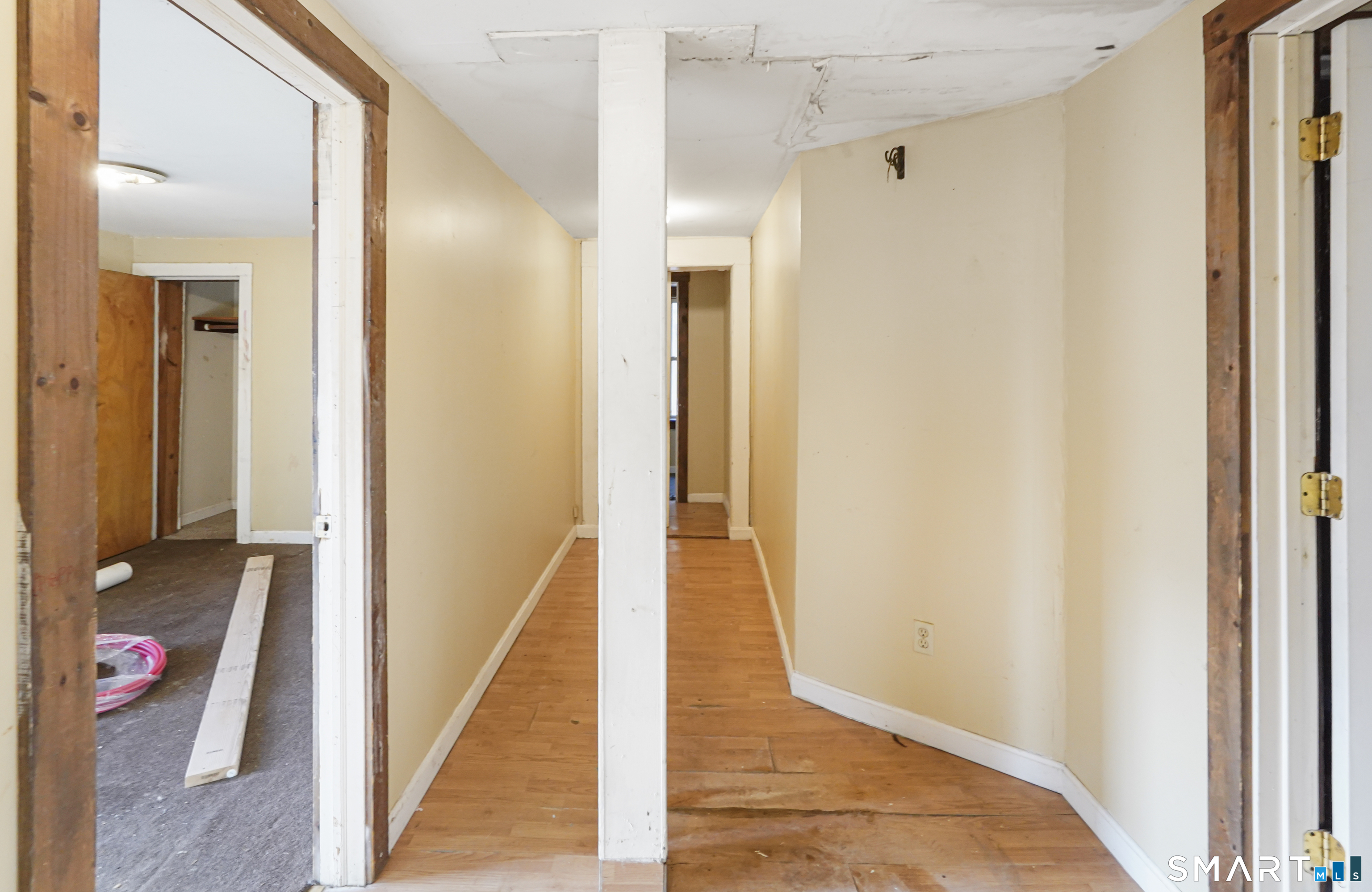 385 Putnam Pike Killingly, CT 06241 - Photo 16 of 40 a view of a hallway with wooden floor and a living room