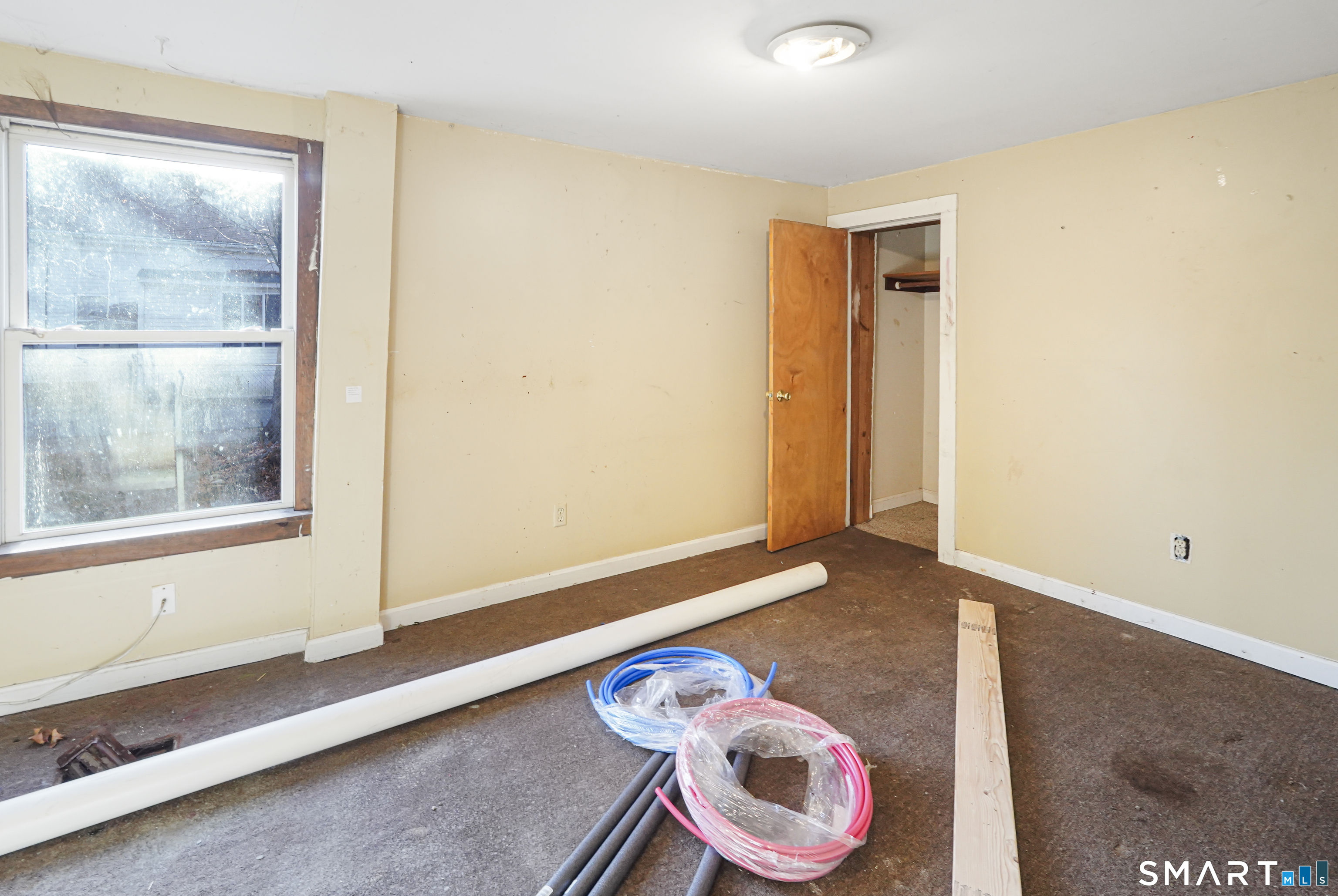 385 Putnam Pike Killingly, CT 06241 - Photo 22 of 40 a bedroom with a bed and a window