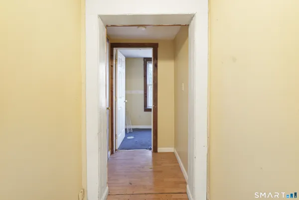 a view of a hallway with wooden floor