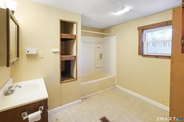 a bathroom with a bathtub and a sink