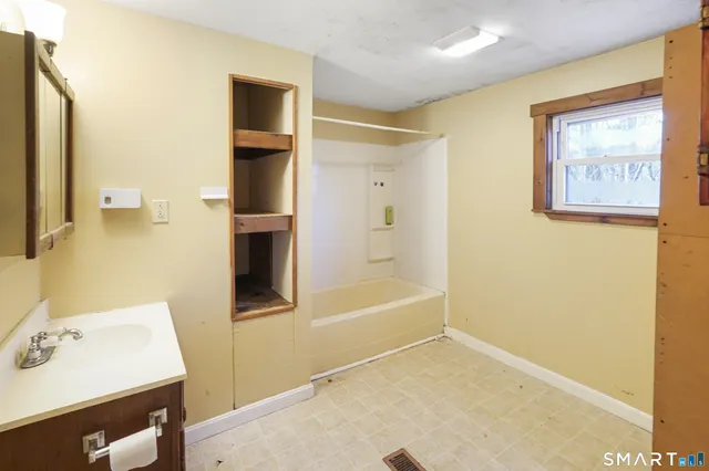 a bathroom with a bathtub and a sink