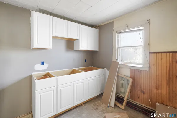 a room with a window and a wooden cabinets