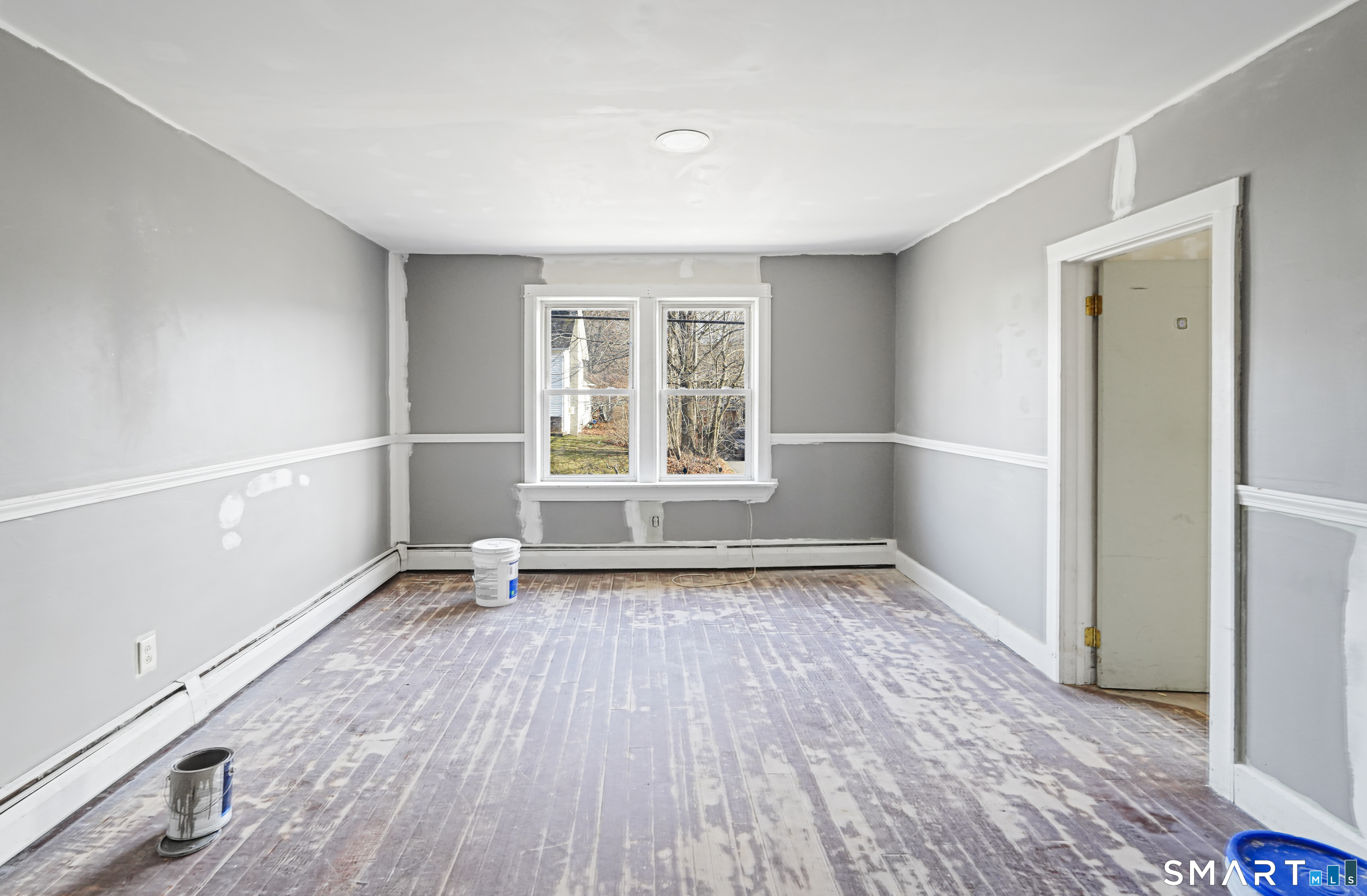 385 Putnam Pike Killingly, CT 06241 - Photo 40 of 40 an empty room with wooden floor and windows