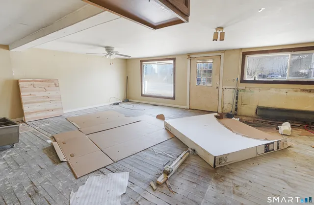 a room with pool table and windows