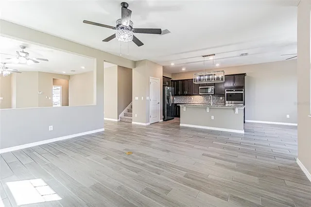 a view of a kitchen with a sink hardwood floor and a window