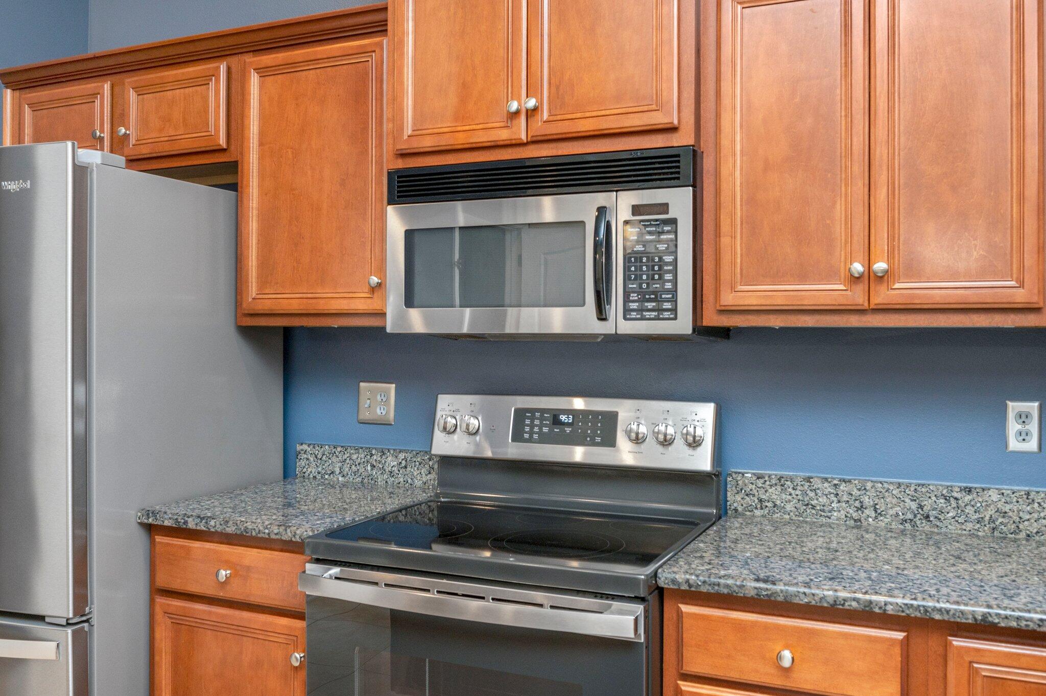 203 Eleases Crossing Crestview, FL 32539 - Photo 12 of 35 a kitchen with granite countertop a stove and a microwave