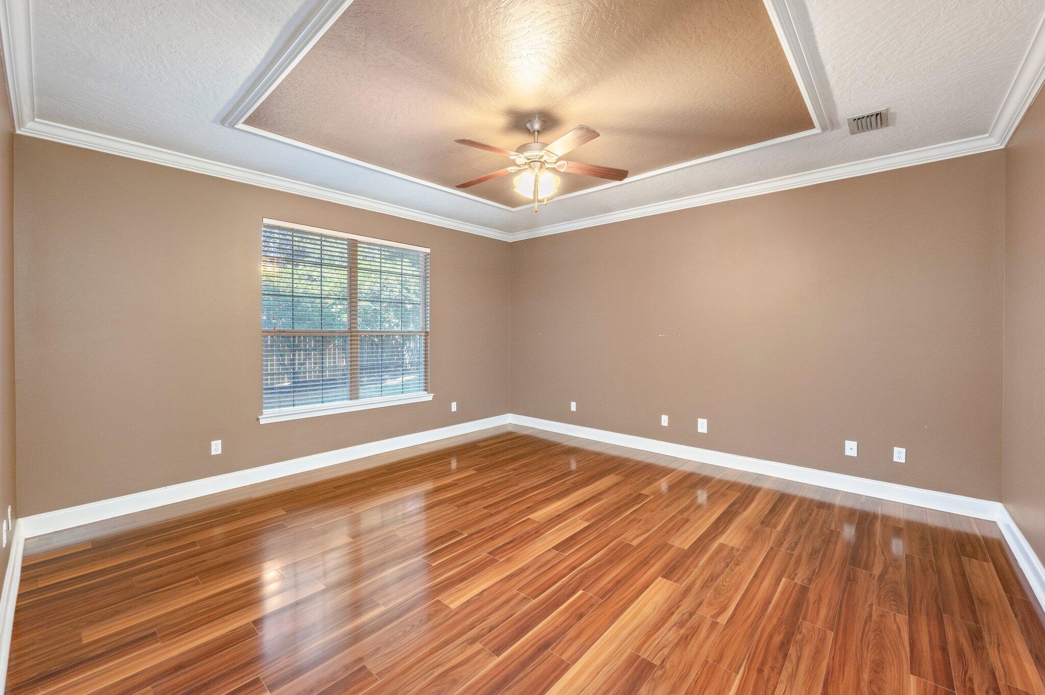 203 Eleases Crossing Crestview, FL 32539 - Photo 15 of 35 wooden floor in an empty room with a window