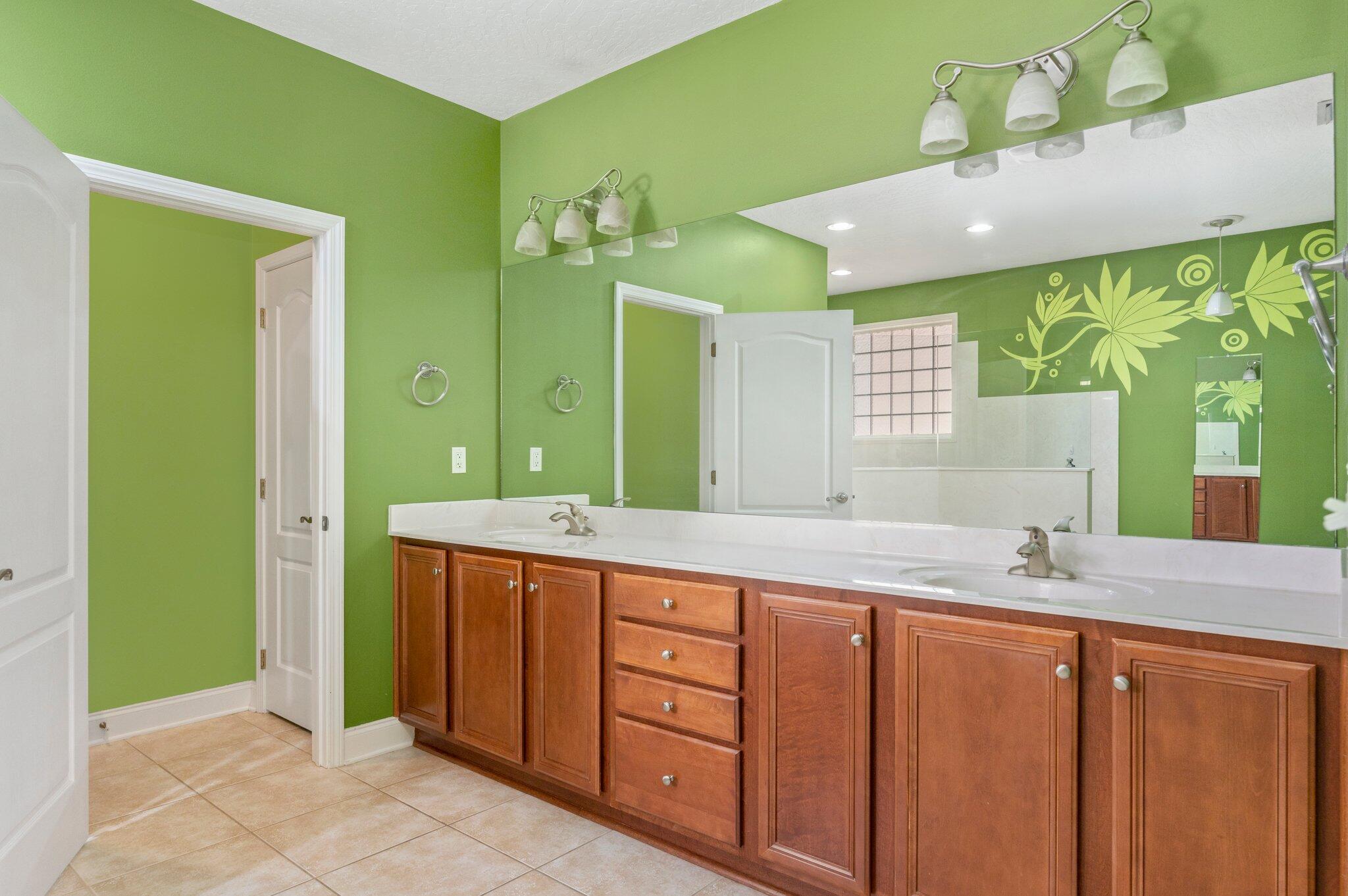 203 Eleases Crossing Crestview, FL 32539 - Photo 17 of 35 a spacious bathroom with a granite countertop sink and a mirror