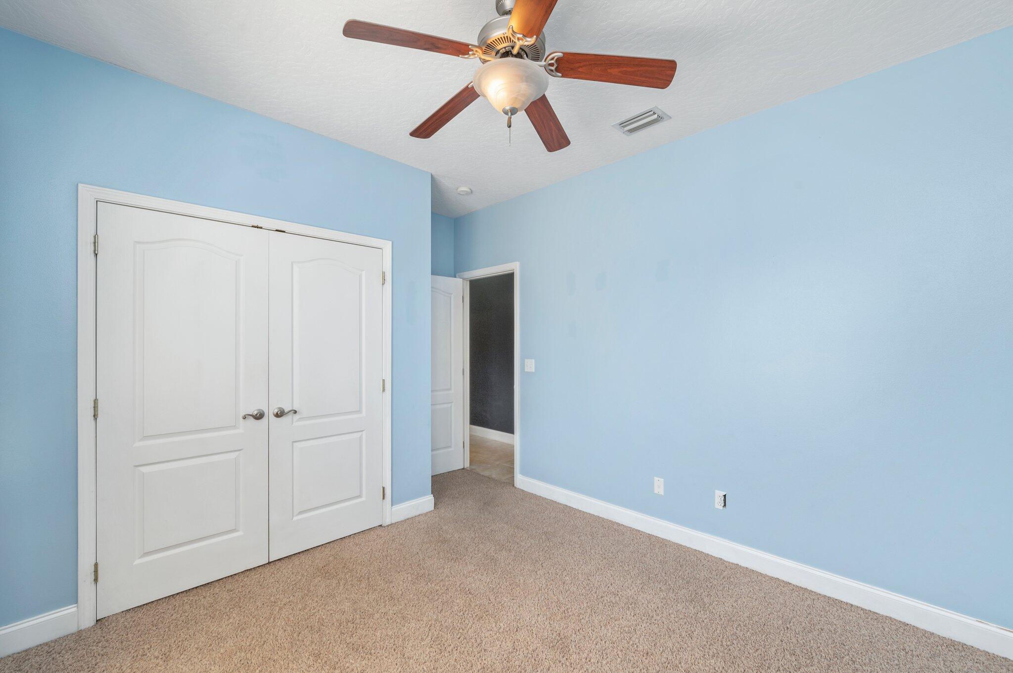 203 Eleases Crossing Crestview, FL 32539 - Photo 25 of 35 an empty room with closet and a ceiling fan