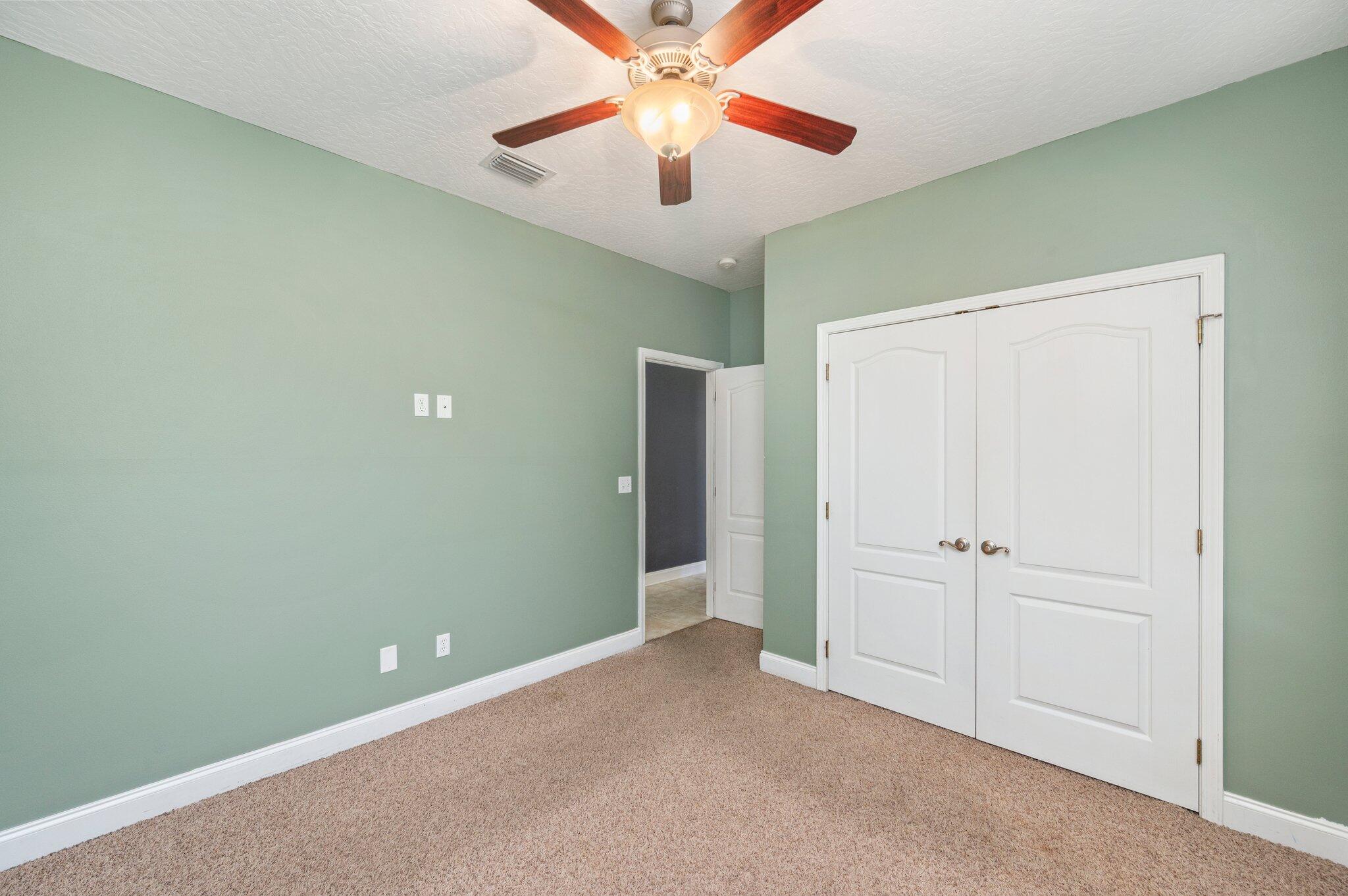 203 Eleases Crossing Crestview, FL 32539 - Photo 27 of 35 an empty room with closet and a chandelier fan