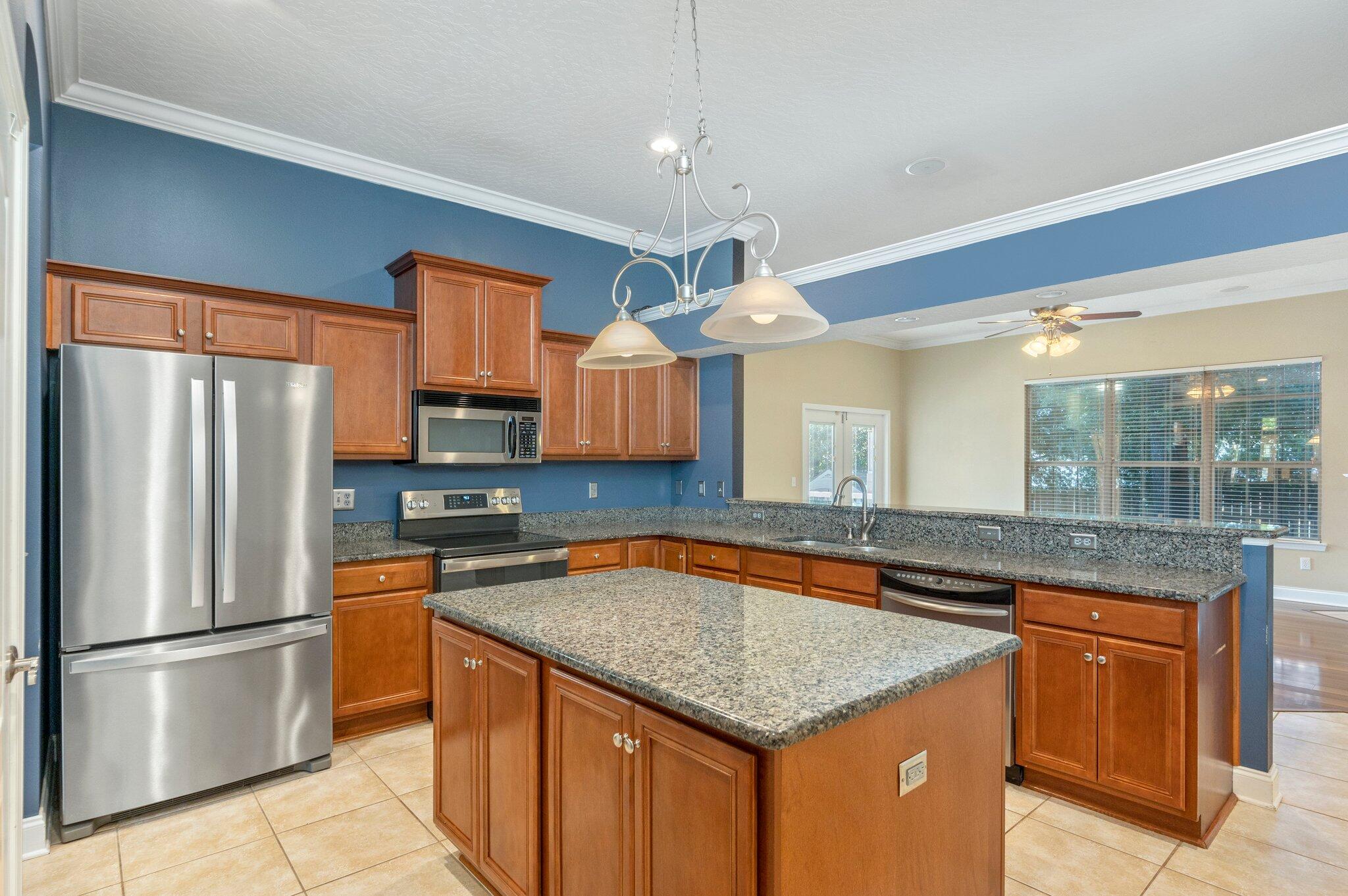 203 Eleases Crossing Crestview, FL 32539 - Photo 10 of 35 a kitchen with stainless steel appliances granite countertop a sink a refrigerator and a stove