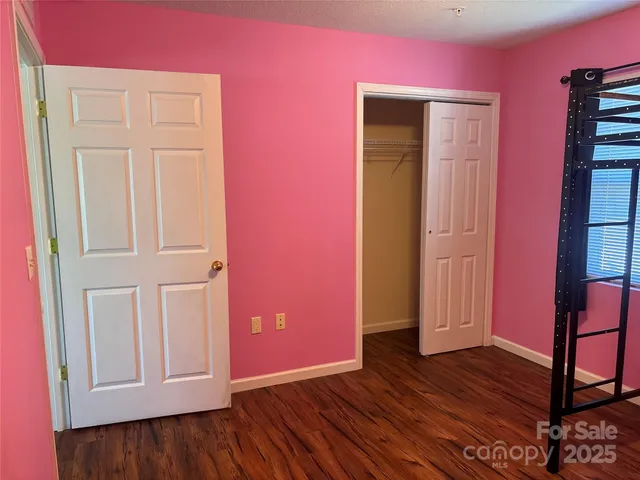 front view of a room with wooden floor and closet