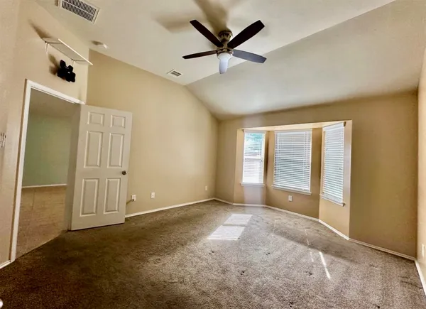 an empty room with windows and closet