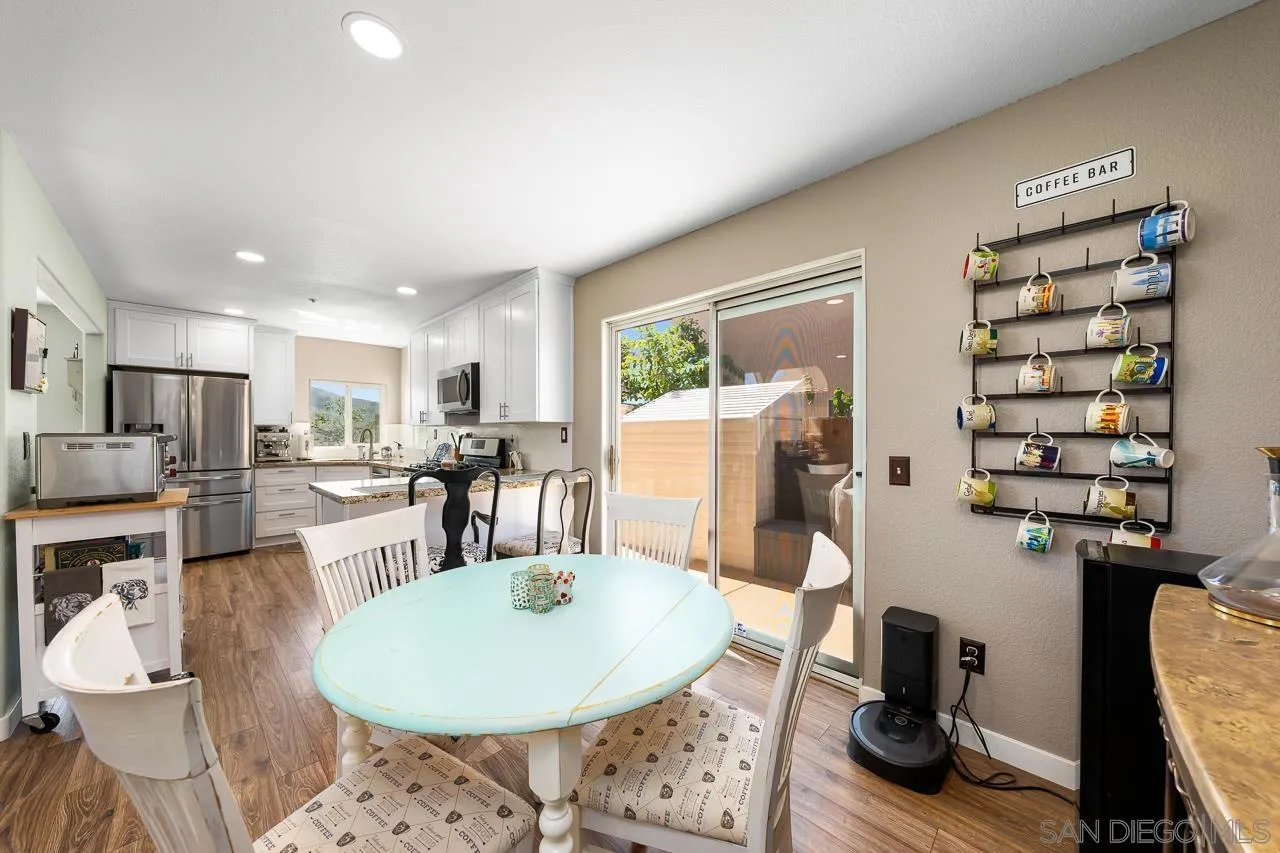 9851 Avenida Ricardo Spring Valley, CA 91977 - Photo 14 of 41 a living room with furniture a dining table and kitchen view with wooden floor