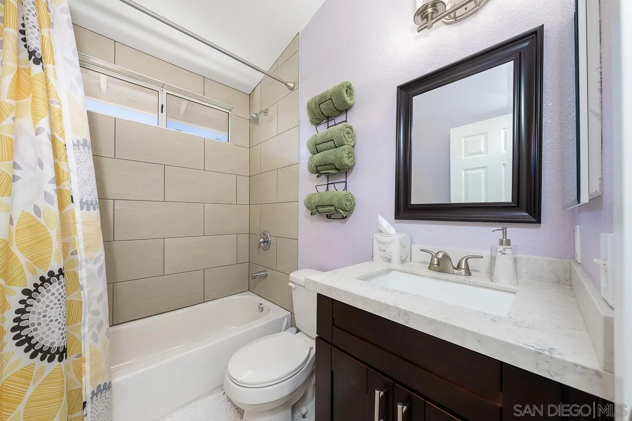 9851 Avenida Ricardo Spring Valley, CA 91977 - Photo 19 of 41 a bathroom with a sink a toilet a mirror a vanity and bathtub