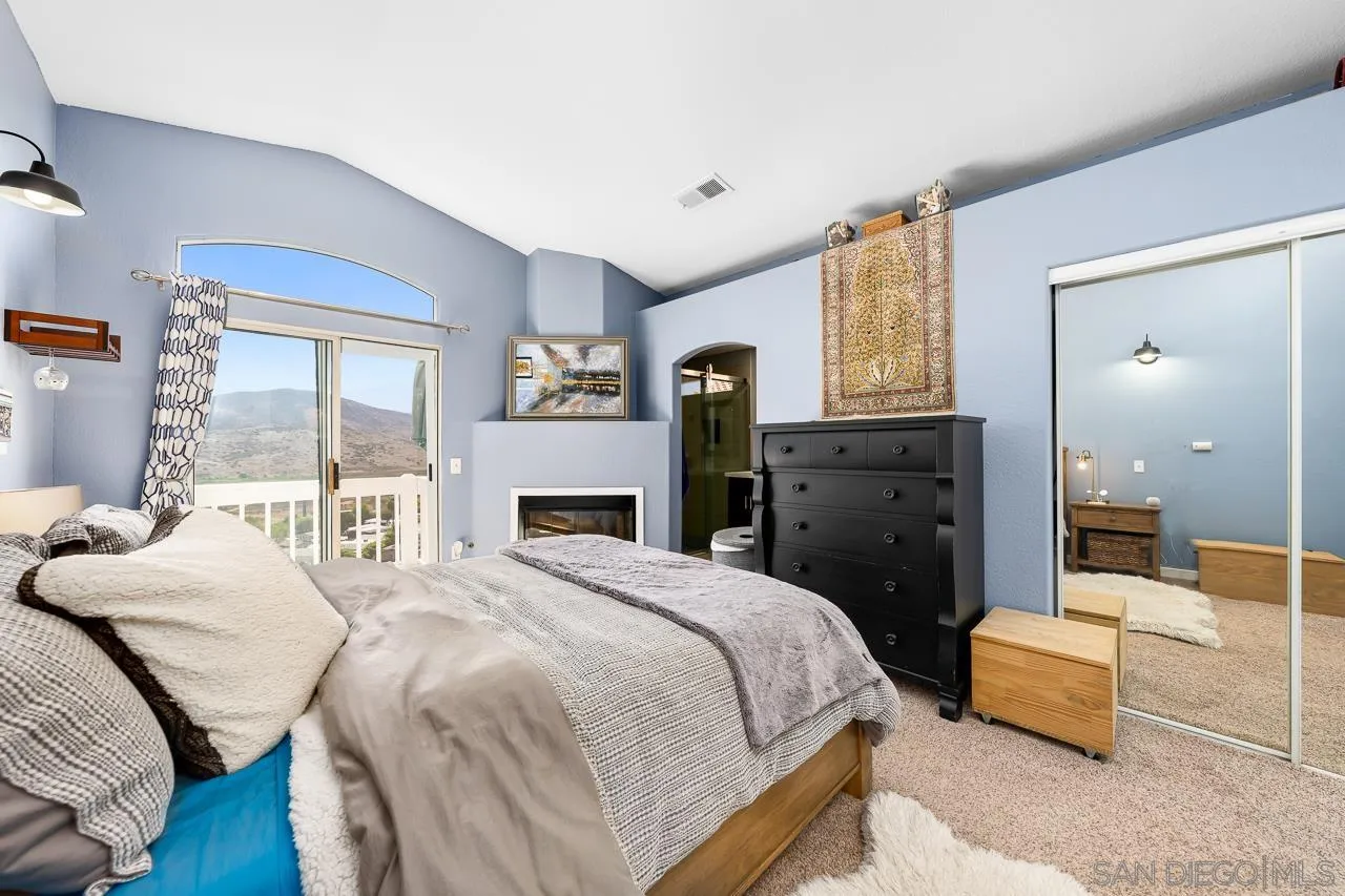 9851 Avenida Ricardo Spring Valley, CA 91977 - Photo 20 of 41 a bedroom with a bed and wooden floor