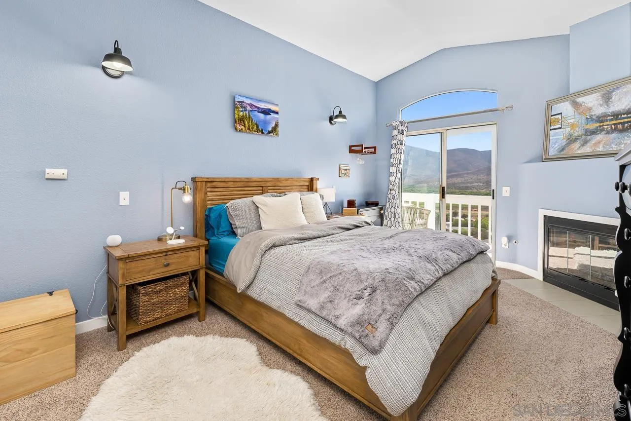 9851 Avenida Ricardo Spring Valley, CA 91977 - Photo 21 of 41 a spacious bedroom with a bed and a fireplace
