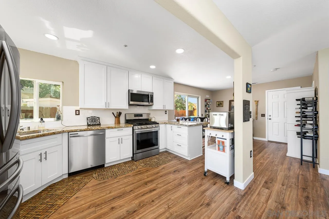 9851 Avenida Ricardo Spring Valley, CA 91977 - Photo 10 of 41 a kitchen with white cabinets stove and white stainless steel appliances