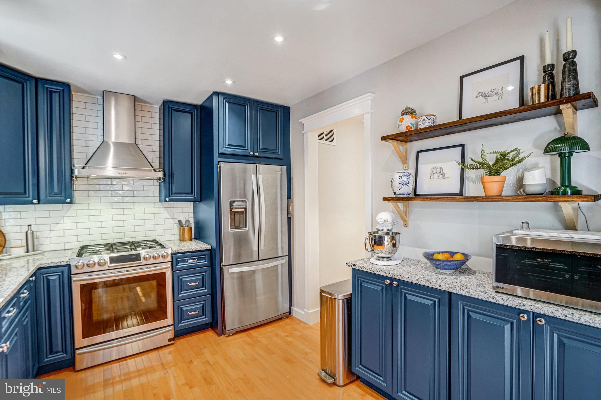 7923 Forest Path Way Springfield, VA 22153 - Photo 11 of 39 a kitchen with stainless steel appliances granite countertop a refrigerator stove and sink