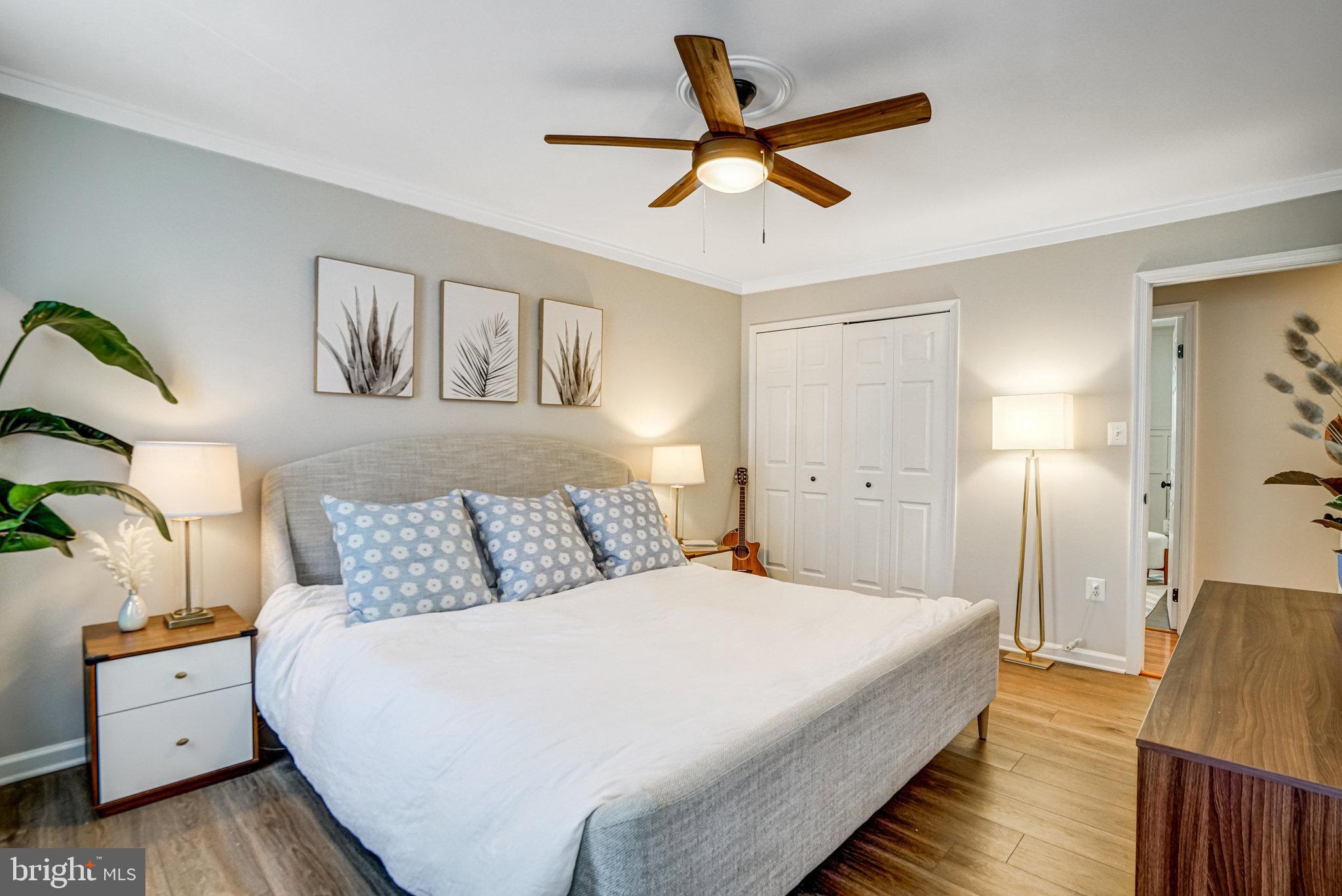 7923 Forest Path Way Springfield, VA 22153 - Photo 16 of 39 a bedroom with a large bed and a chandelier