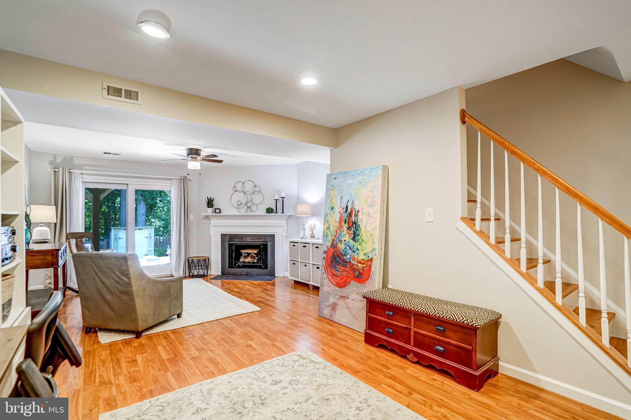 7923 Forest Path Way Springfield, VA 22153 - Photo 30 of 39 a living room with furniture a fireplace and a flat screen tv