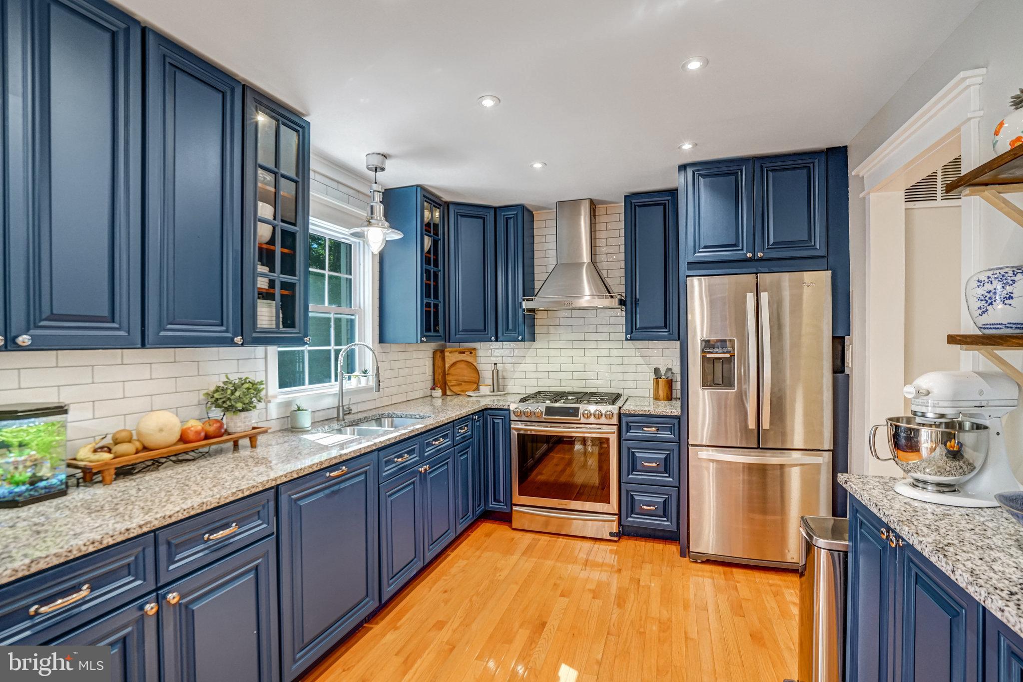 7923 Forest Path Way Springfield, VA 22153 - Photo 10 of 39 a kitchen with stainless steel appliances granite countertop a refrigerator stove and sink