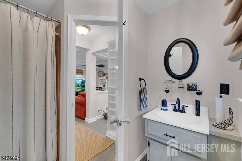 233 Maple Avenue Dunellen, NJ 08812 - Photo 19 of 39 a bathroom with a sink mirror and shower