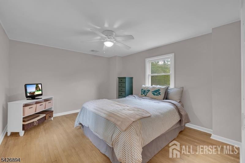 233 Maple Avenue Dunellen, NJ 08812 - Photo 23 of 39 a bedroom with a large bed and a chandelier