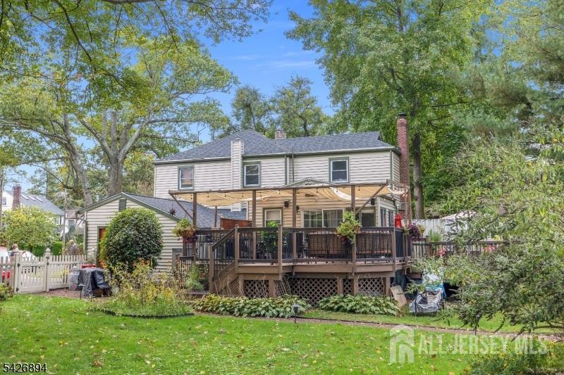 233 Maple Avenue Dunellen, NJ 08812 - Photo 28 of 39 a view of house with a big yard and large trees