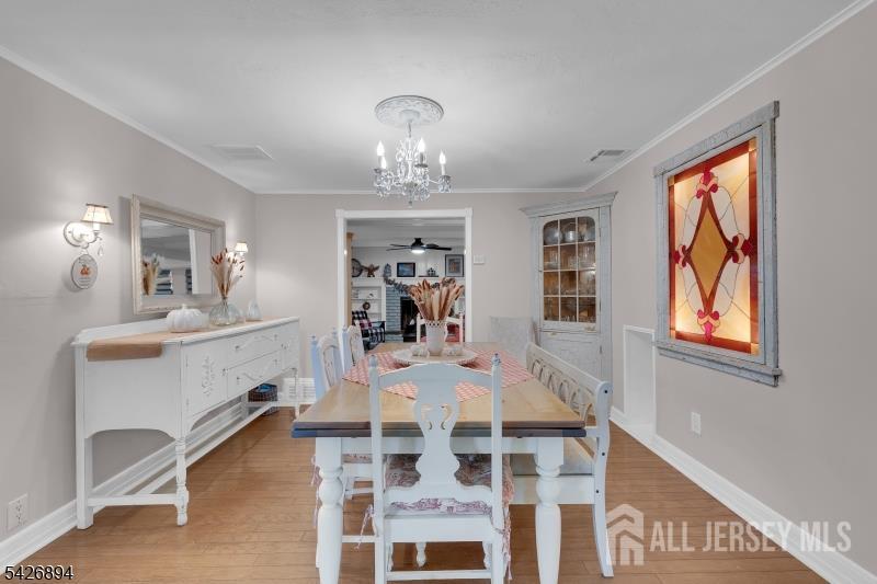233 Maple Avenue Dunellen, NJ 08812 - Photo 9 of 39 a view of a dining room with furniture and chandelier