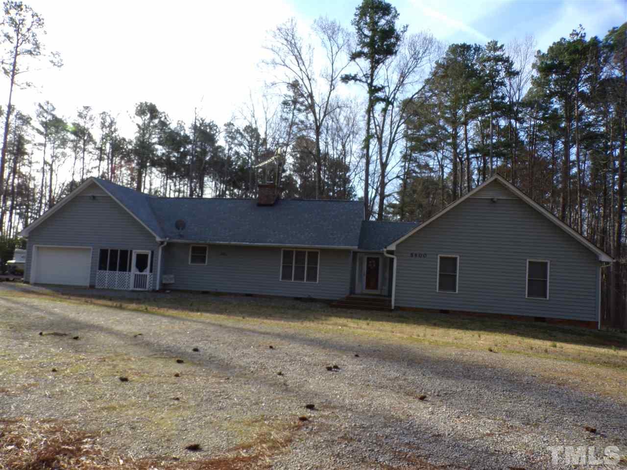 5400 Thomas Road Henderson, NC 27537 - Photo 1 of 8 a house that has a tree in front of it