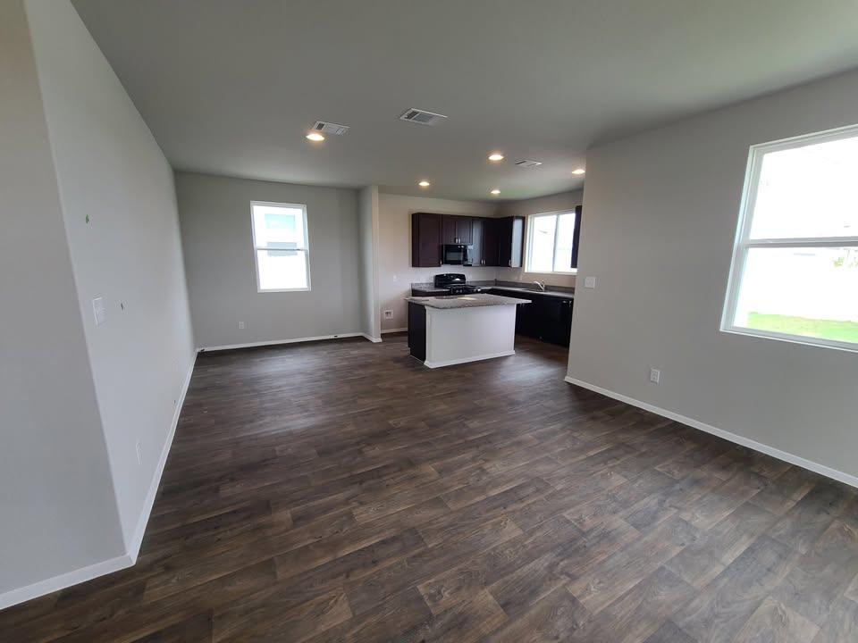 156 Huckleberry Lane Elgin, TX 78621 - Photo 15 of 16 An open floorplan seamlessly connects the living space to the inviting kitchen, perfect for daily living.