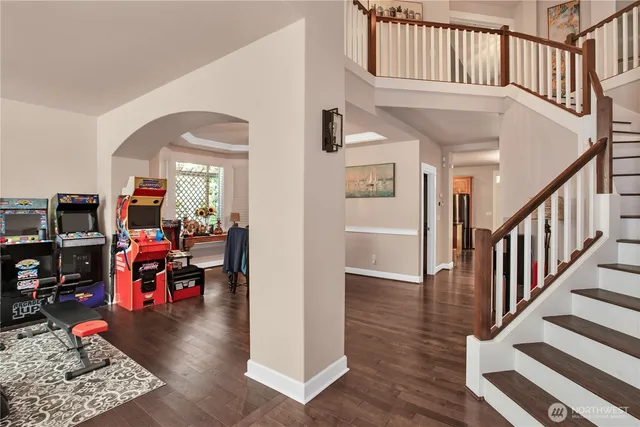 a view of entryway and hall with wooden floor