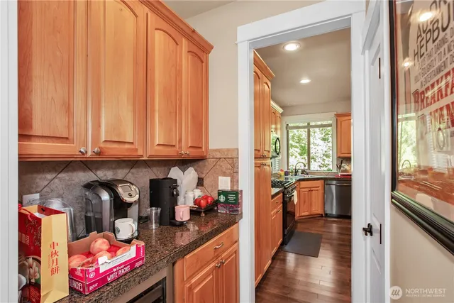 a kitchen with granite countertop lots of appliances and cabinets