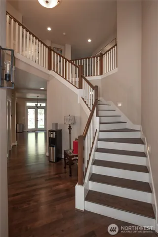 a view of entryway and hall with wooden floor