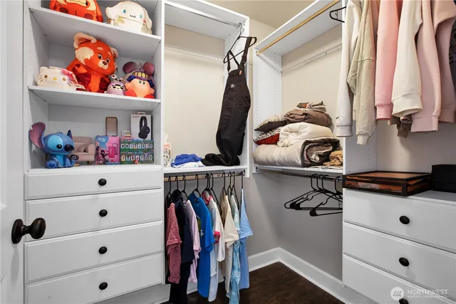 a view of walk in closet with clothes and shoes