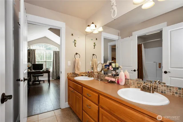 a bathroom with a sink double vanity and a mirror